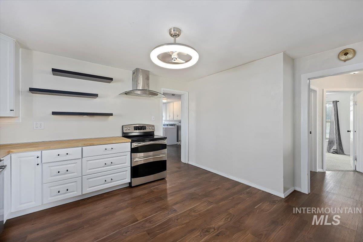810 South 9th Street Rupert, ID 83350 - Photo 9 of 31 Kitchen with open shelves, white cabinets, double oven range, ventilation hood, and dark wood-style flooring