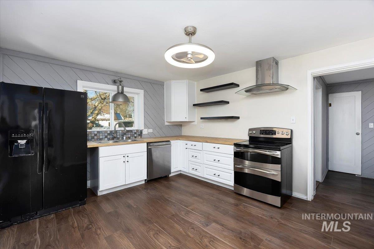 810 South 9th Street Rupert, ID 83350 - Photo 10 of 31 Kitchen with open shelves, white cabinetry, stainless steel appliances, ventilation hood, and dark wood-style flooring