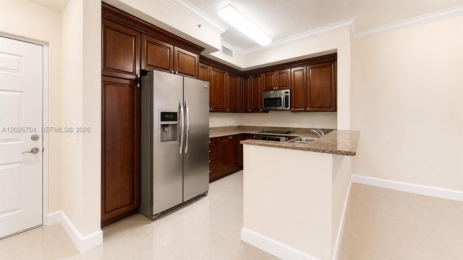 4106 Renaissance Way, Unit 106 Boynton Beach, FL 33426 - Photo 4 of 14 a kitchen with stainless steel appliances granite countertop a refrigerator and a stove