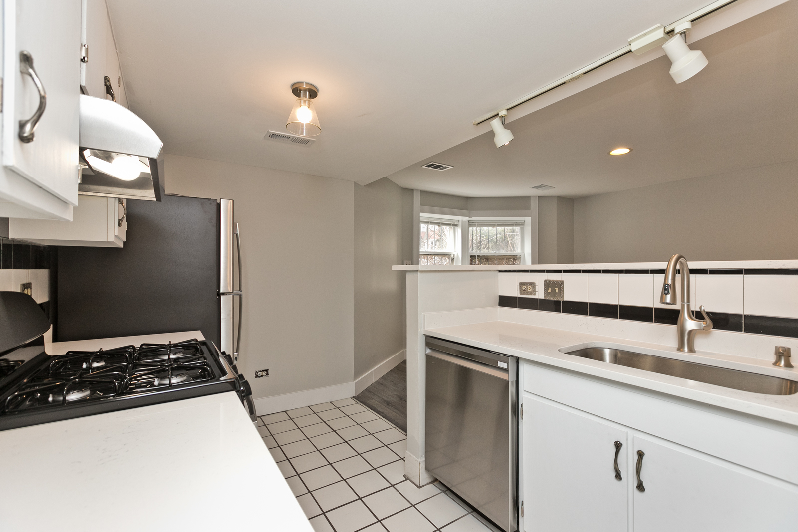 4061 North Sheridan Road, Unit G Chicago, IL 60613 - Photo 4 of 10 a kitchen with a sink appliances and cabinets