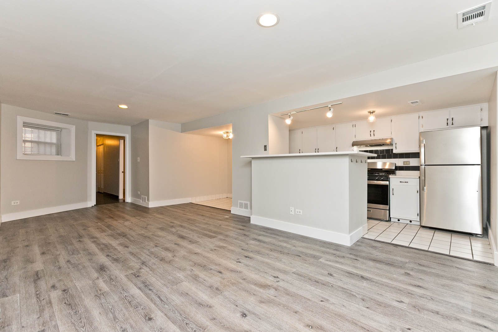 4061 North Sheridan Road, Unit G Chicago, IL 60613 - Photo 5 of 10 a view of a kitchen with a refrigerator a stove top oven