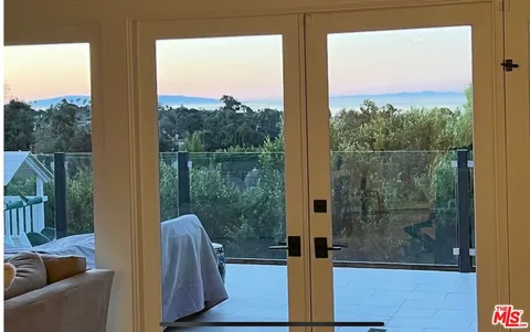 a view of a glass door and a balcony