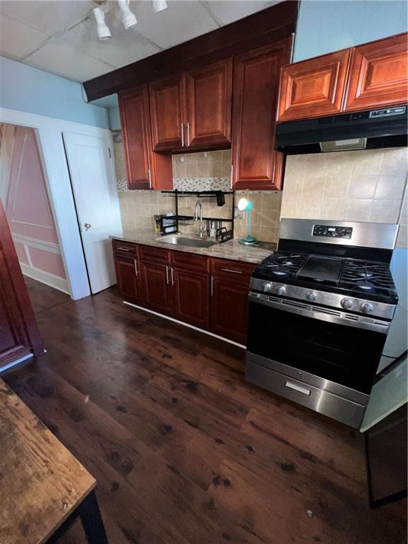 3317 Clarendon Road Brooklyn, NY 11203 - Photo 3 of 11 a kitchen with wooden cabinets and a stove top oven
