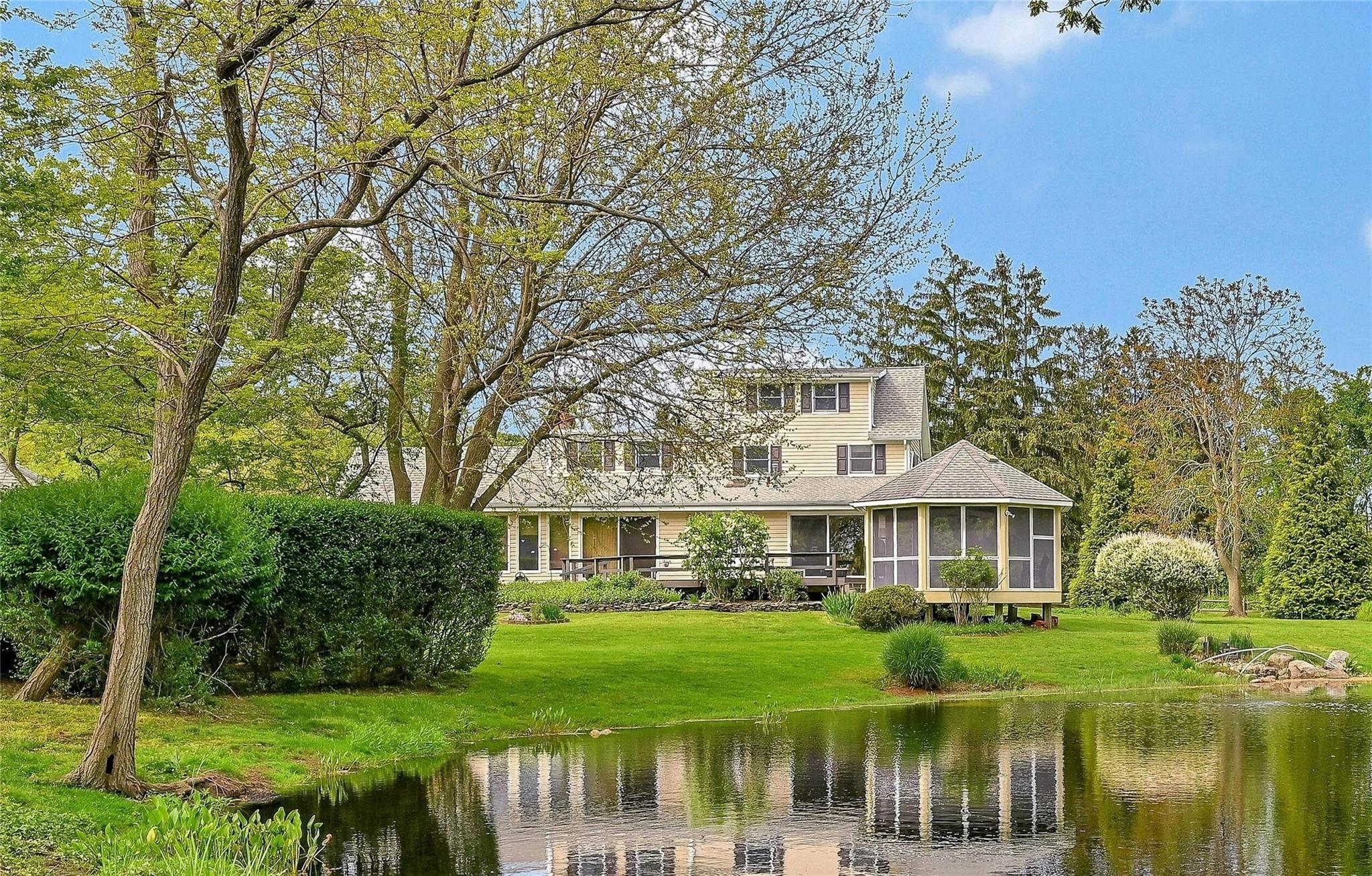 540 Cedars Road Cutchogue, NY 11935 - Photo 1 of 1 View of rear of house featuring a gazebo, and a water view of the pond. on 1+ acres