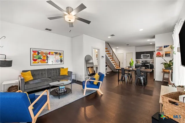 a living room with lots of furniture and a flat screen tv