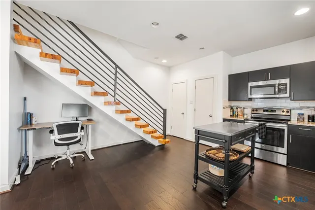 a room with wooden floor and furniture