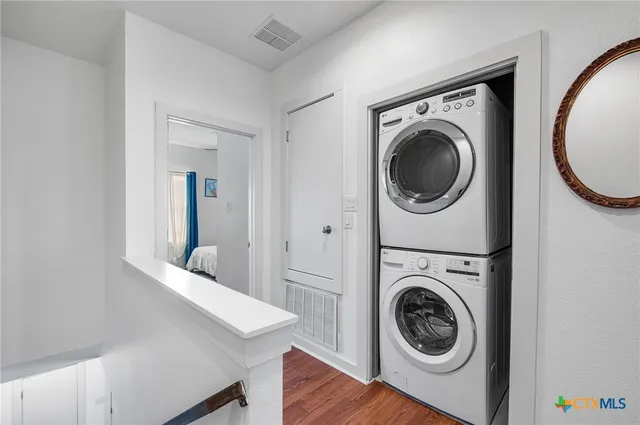 a view of a hallway with washer and dryer