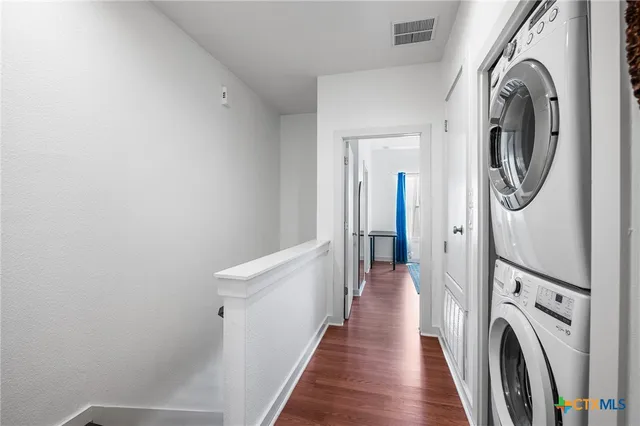 a view of a hallway with washer and dryer