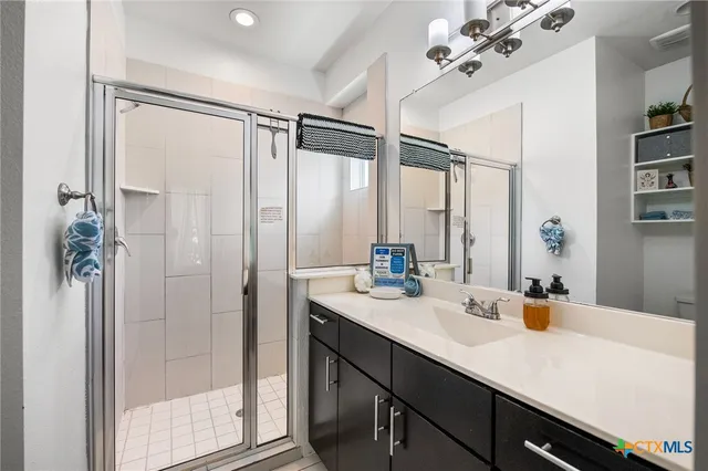 a bathroom with a sink double vanity and a mirror