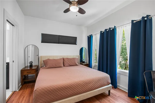 a bedroom with a bed and a television