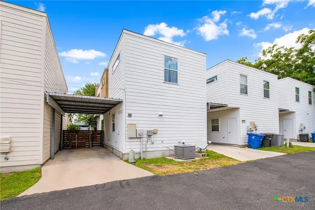 a view of a patio with a table and chairs and a fire pit