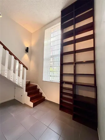 a view of staircase with a white cabinets