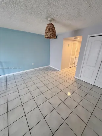 a view of a hallway to rooms and stairs