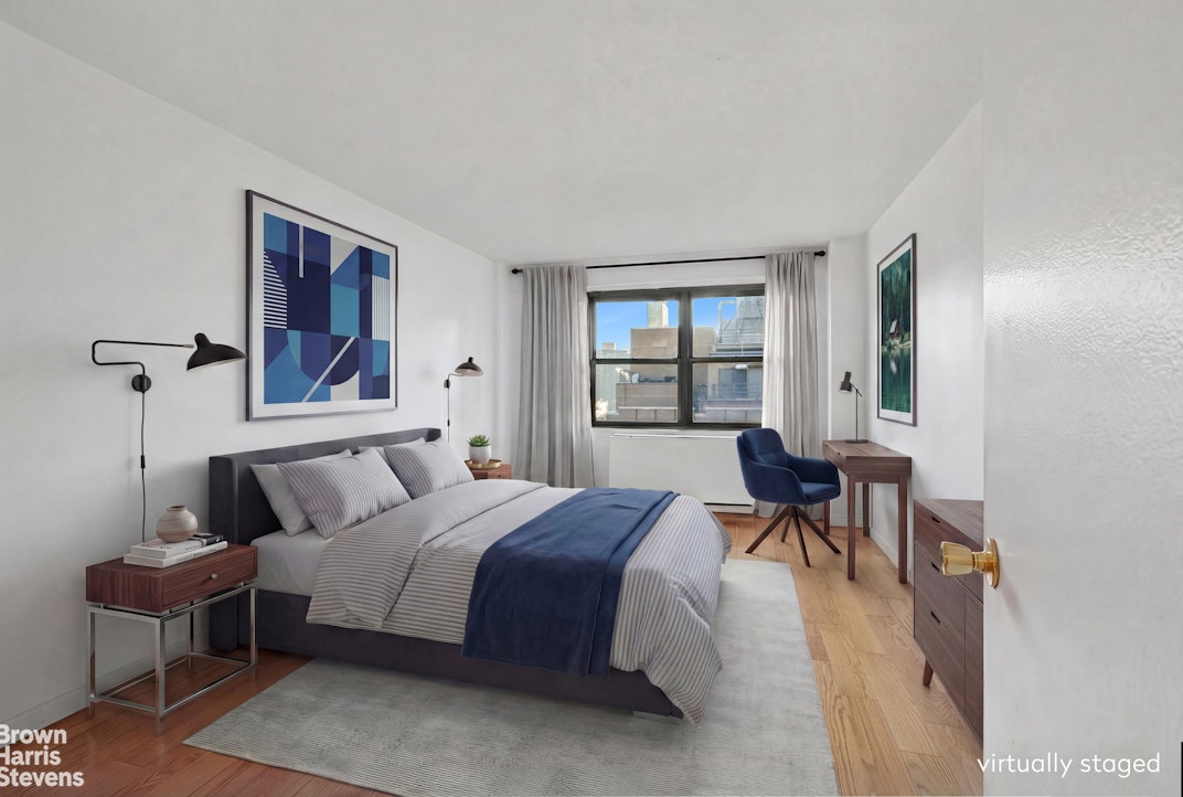 132 East 35th Street, Unit 16F Manhattan, NY 10016 - Photo 6 of 14 a bedroom with a bed and a table in it