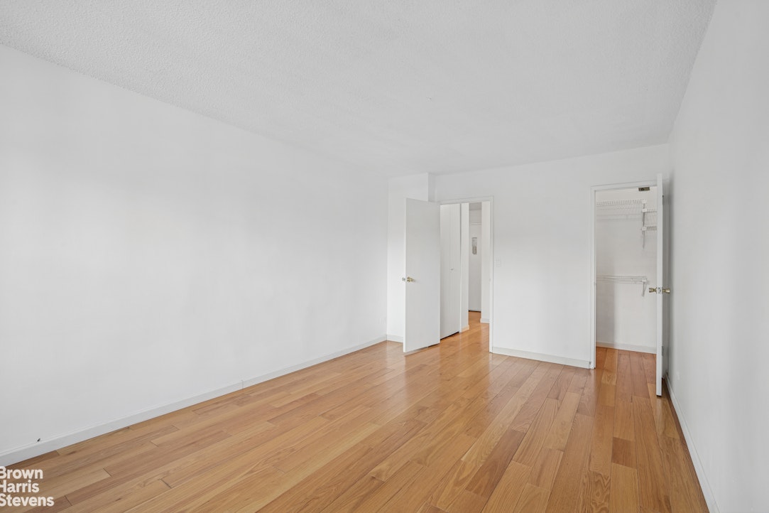 132 East 35th Street, Unit 16F Manhattan, NY 10016 - Photo 9 of 14 a view of an empty room with wooden floor