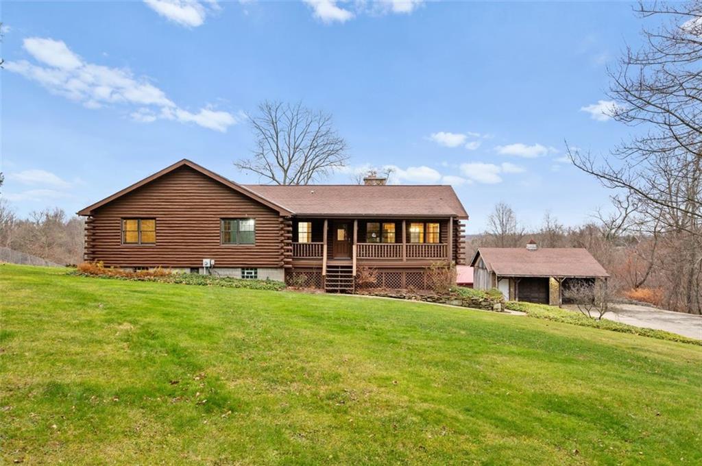 5150 Beech Road Apollo, PA 15613 - Photo 35 of 37 a front view of a house with a garden and porch