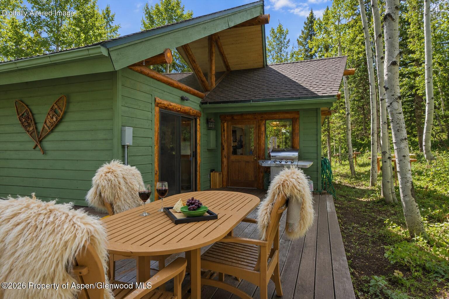 818 Faraway Road Snowmass Village, CO 81615 - Photo 8 of 35 a view of a patio with table and chairs with wooden floor and fence