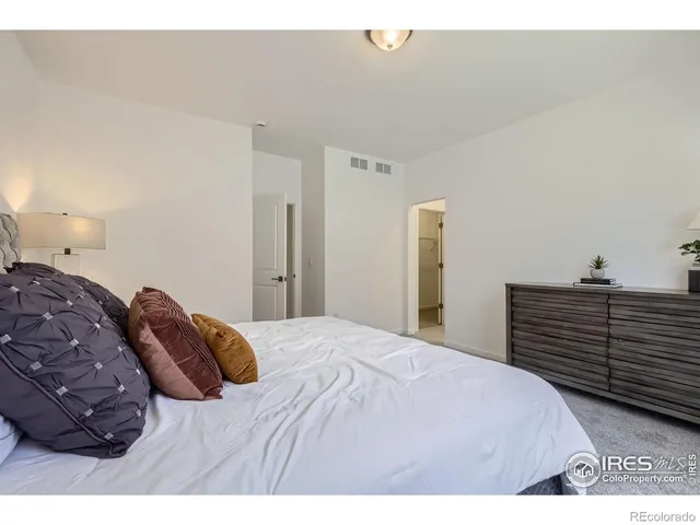 a bedroom with a bed and cabinets