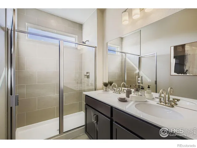 a bathroom with a sink mirror and a shower