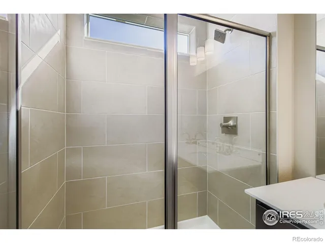 a bathroom with a shower and a sink