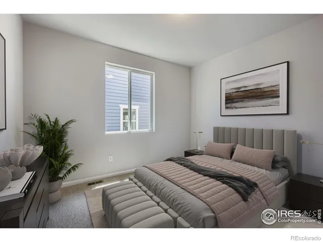 a bedroom with a large bed and a potted plant