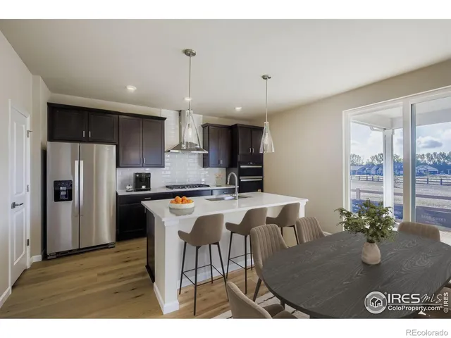 a kitchen with a table and chairs in it