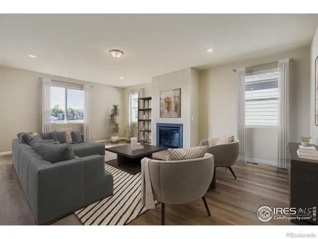 a living room with fireplace furniture and a wooden floor