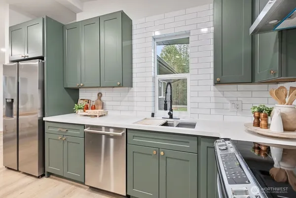 a kitchen with a sink stove and cabinets