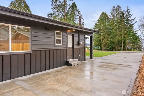 a view of backyard with deck and wooden fence