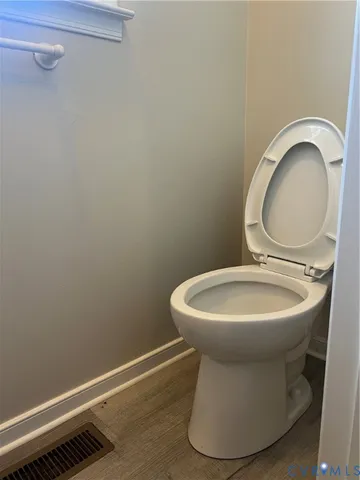 a white toilet sitting next to a sink