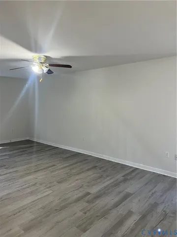 a view of a room with wooden floor