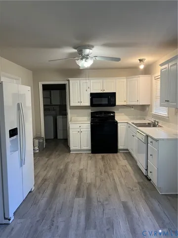 a kitchen with stove cabinets and refrigerator