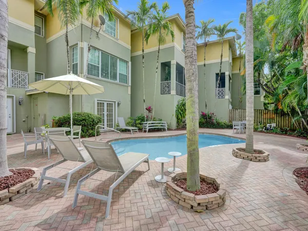 a view of a patio with couches chairs and potted plants