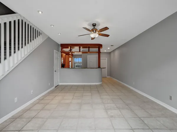 a view of a livingroom with a ceiling fan and window