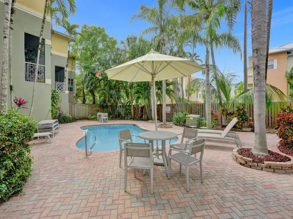 a view of backyard with outdoor seating and plants