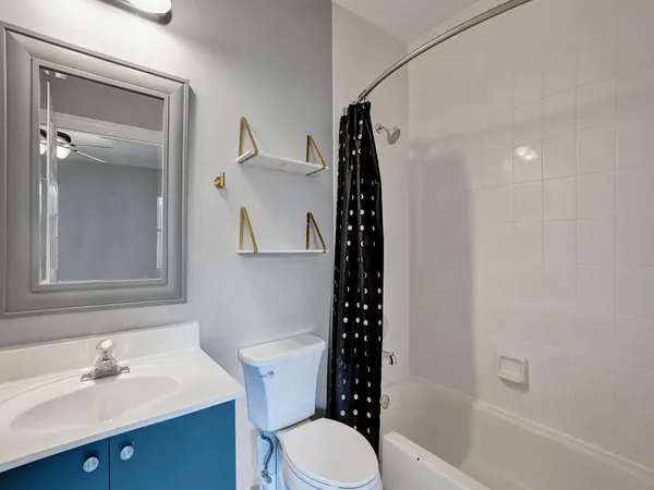 a bathroom with a sink mirror toilet and shower