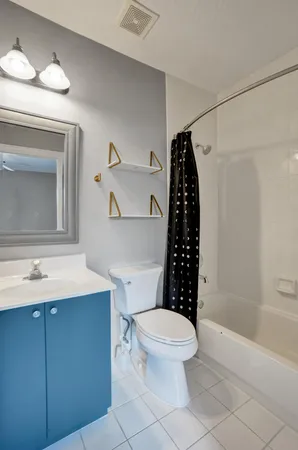 a white toilet sitting next to a bathroom sink