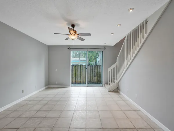 a view of room with window and ceiling fan