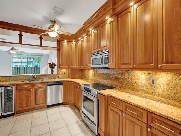 a kitchen with stainless steel appliances granite countertop a sink and cabinets