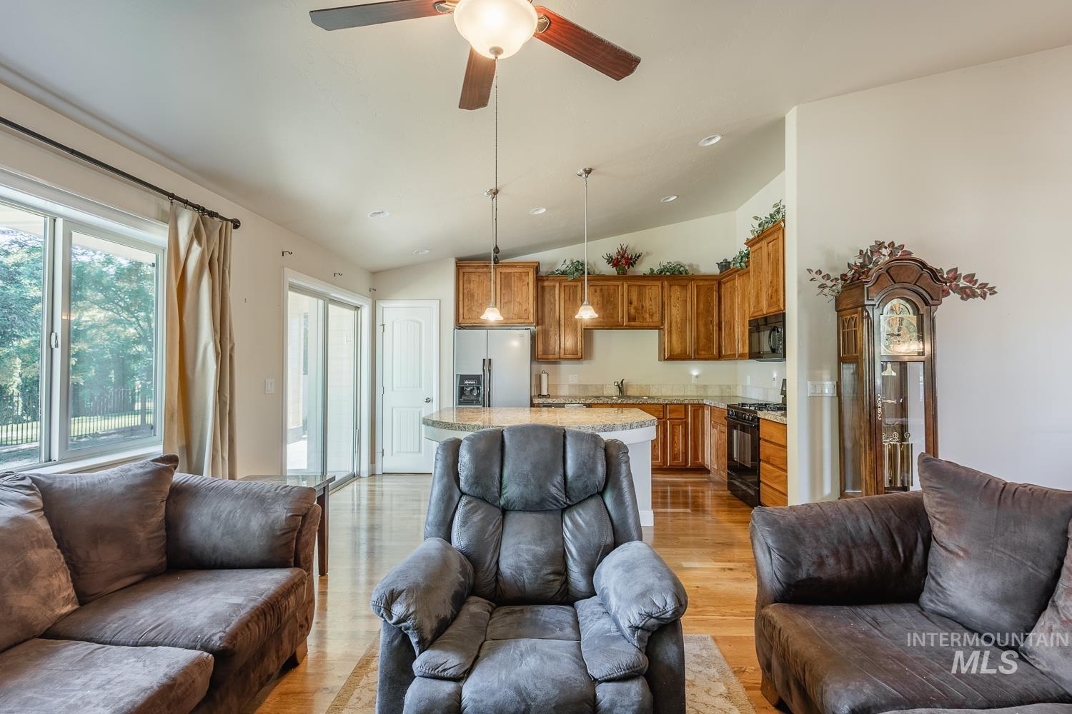 1186 East Observation Street Meridian, ID 83642 - Photo 11 of 33 Open-concept living area featuring wood-finish flooring, a ceiling fan with integrated lighting, and recessed lighting