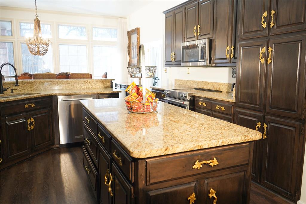 286 West Ridge Street Decatur, TX 76234 - Photo 14 of 35 a kitchen with stainless steel appliances granite countertop a sink stove and refrigerator