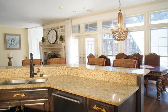 a view of kitchen with granite countertop stove top oven and cabinets
