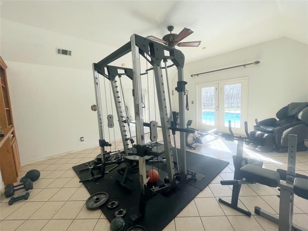 286 West Ridge Street Decatur, TX 76234 - Photo 18 of 35 a room with lots of chairs and mirrors