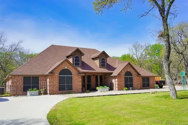 a front view of house with yard and green space