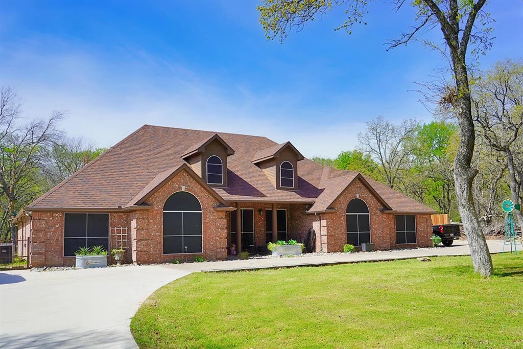 286 West Ridge Street Decatur, TX 76234 - Photo 2 of 35 a front view of house with yard and green space