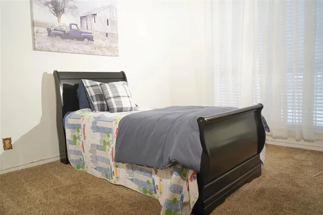 a bedroom with a bed and a dresser