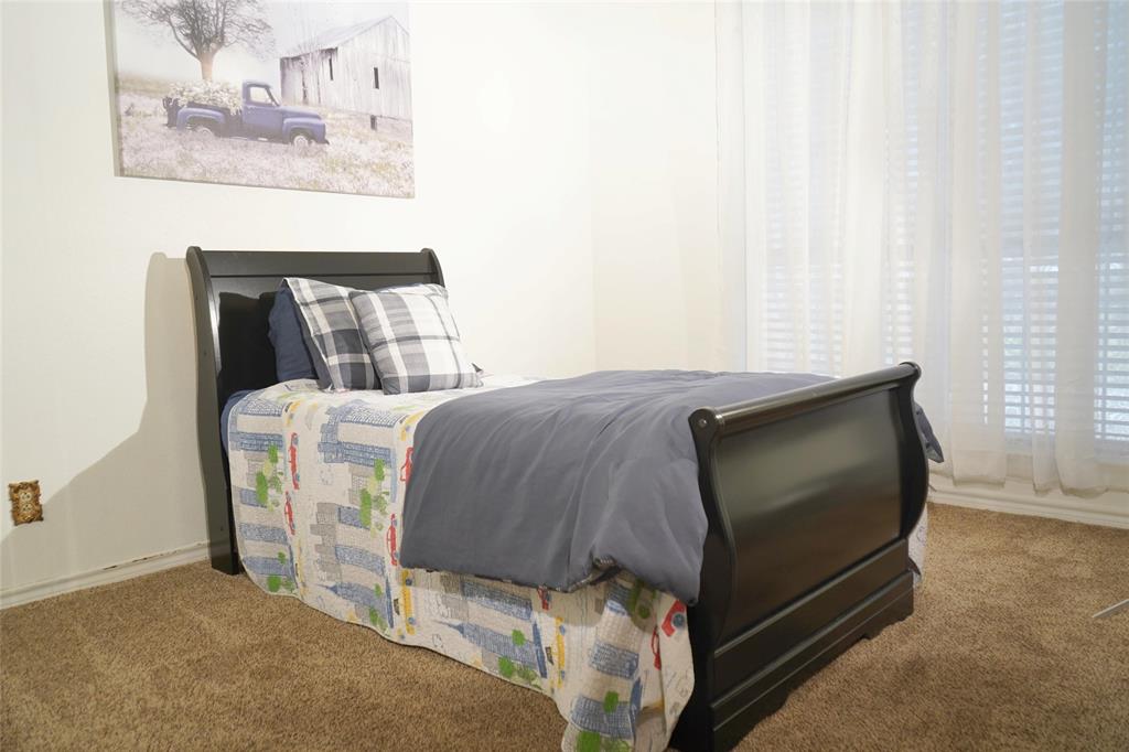 286 West Ridge Street Decatur, TX 76234 - Photo 29 of 35 a bedroom with a bed and a flat screen tv