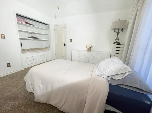 a bathroom with a granite countertop toilet sink and mirror