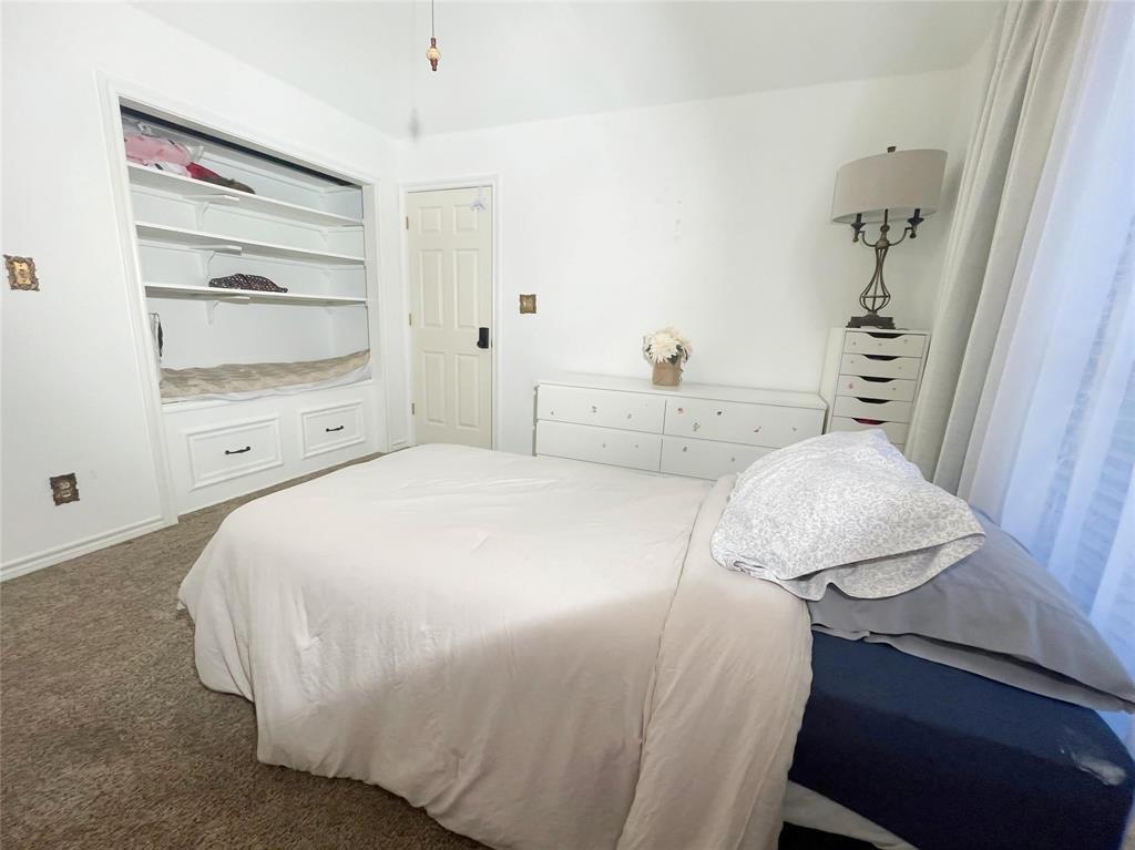 286 West Ridge Street Decatur, TX 76234 - Photo 30 of 35 a bedroom with a bed and a dresser