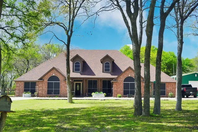 a front view of house with yard and green space